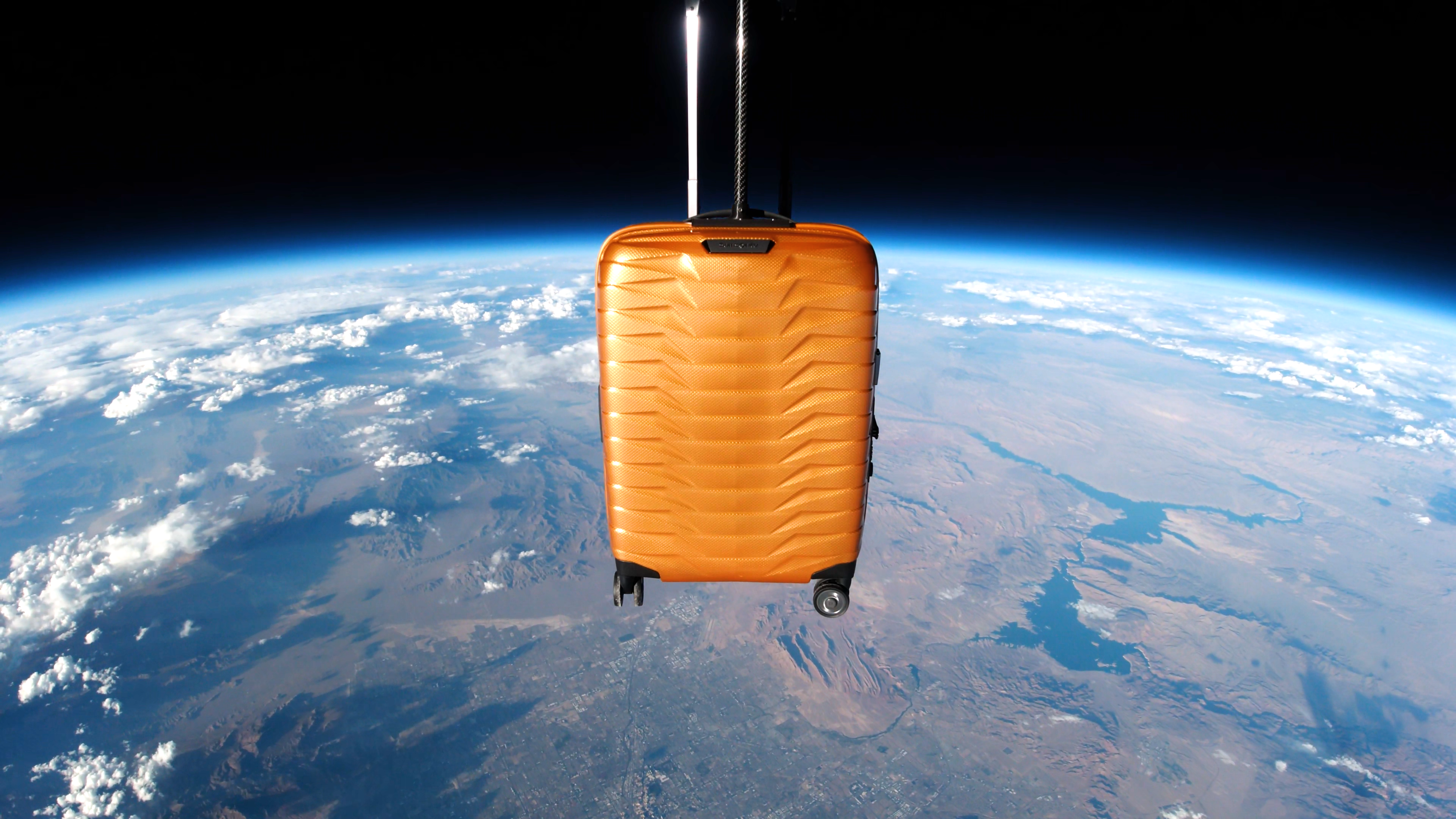 Samsonite's Proxis Carry-on Suitcase floating 130,000 feet above Earth. Image source: Samsonite, Sent Into Space